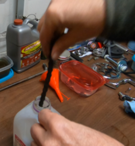 Bicycle chain cleaning in a milk jug.