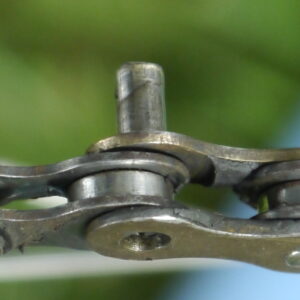 Link pin driven out of chain for removal.