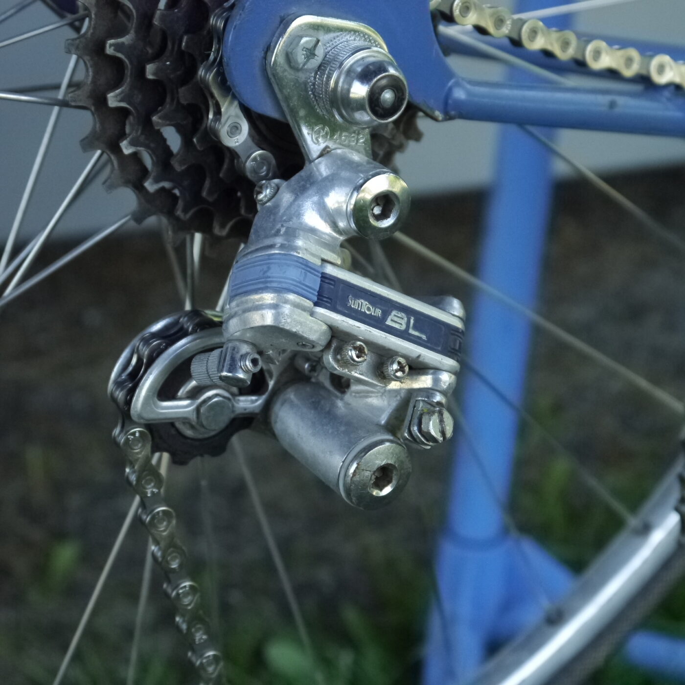 Threading the clean chain through the rear derailleur.