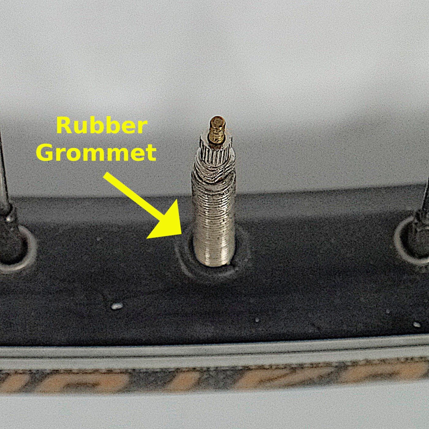 Rubber grommet installed to convert rim drilled for Schrader valves to Presta.